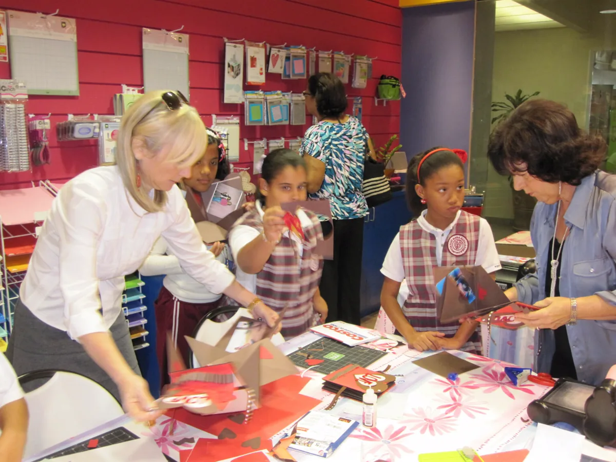 Students and volunteers working together during an arts activity