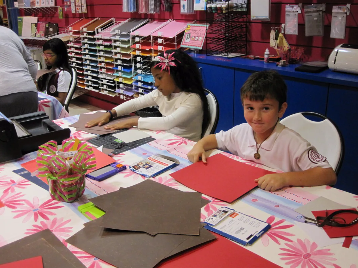 A student creating a classroom art project with educational materials